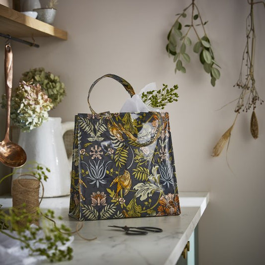 Bolsa pequeña plastificada con dibujo de hojas y pájaros
