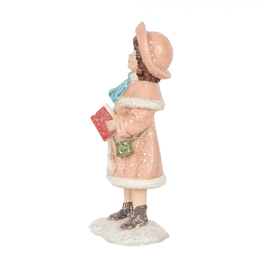 Figura decorativa infantil – Niña con abrigo rosa y libro de villancicos