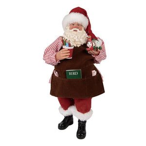 Figura de Santa Claus con delantal, juguetes y lápices