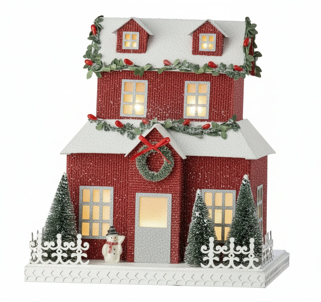 Casa de Pueblo Navideña con Purpurina Roja, Valla y Muñeco de Nieve ( 26.5 cm)